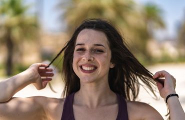 woman in black tank top smiling